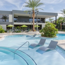 Evolve exterior of apartment with outdoor pool and lounge chairs